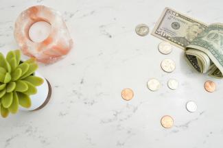 Money, plant and candle on the table
