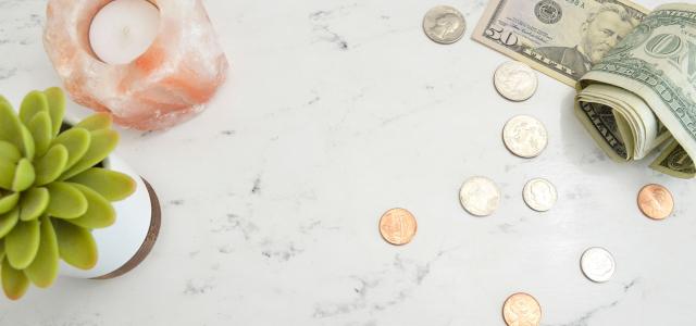 Money, plant and candle on the table